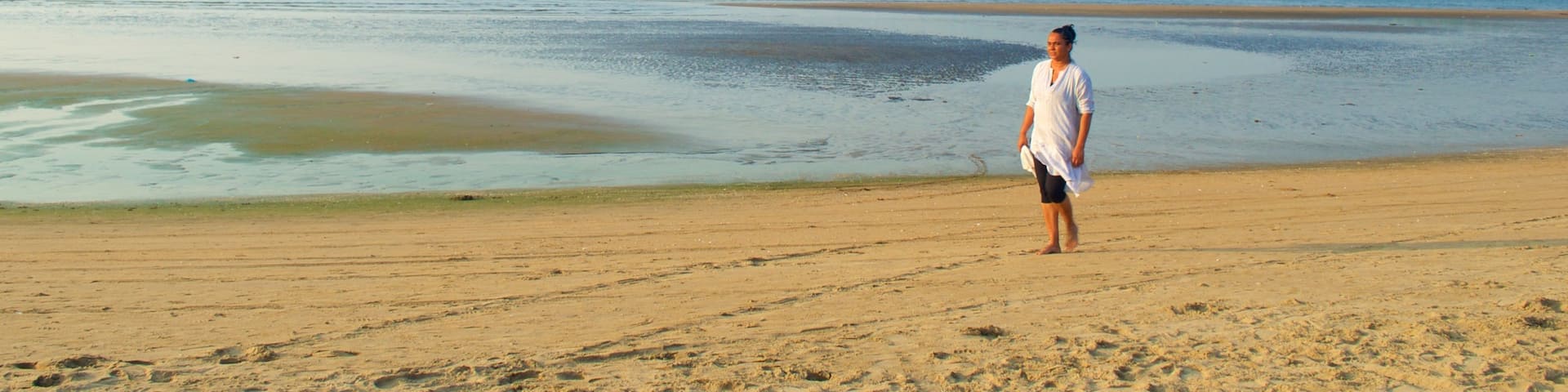 Miramar Beach which includes a beach and general coastal views as well as an individual female