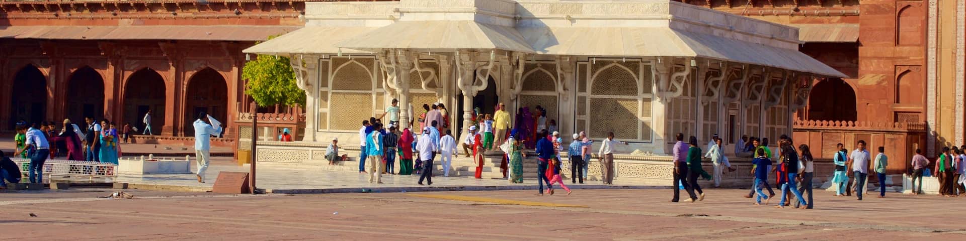 Fatehpur Sikri featuring a mosque and a square or plaza as well as a large group of people