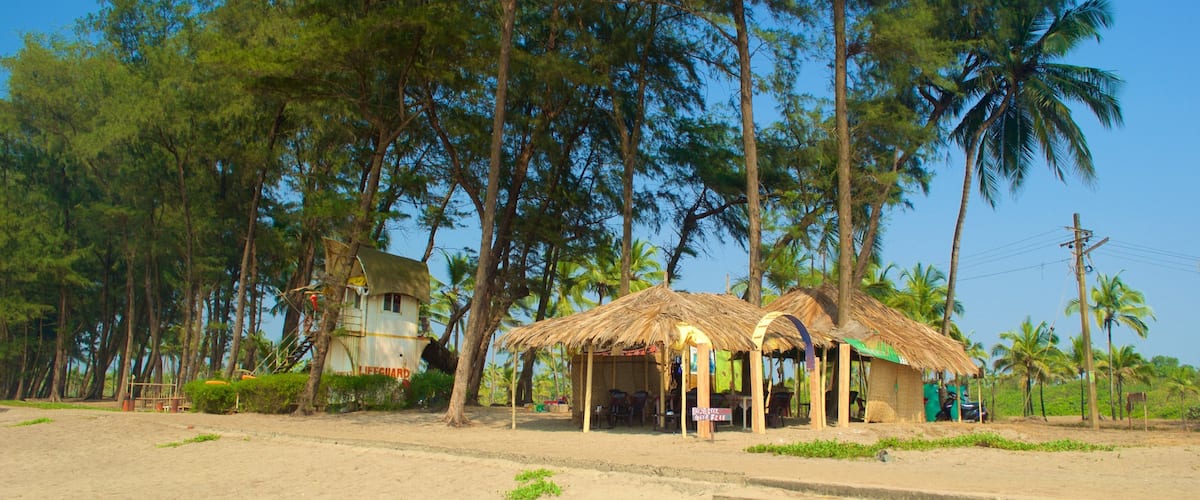 Querim Beach which includes a small town or village, a sandy beach and tropical scenes