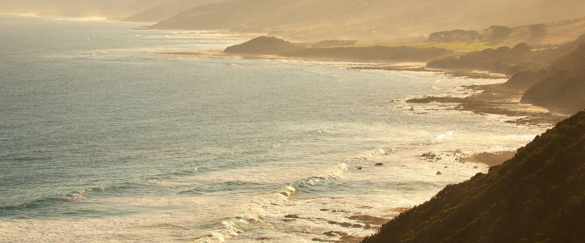 Great Ocean Road featuring general coastal views, a sunset and mountains