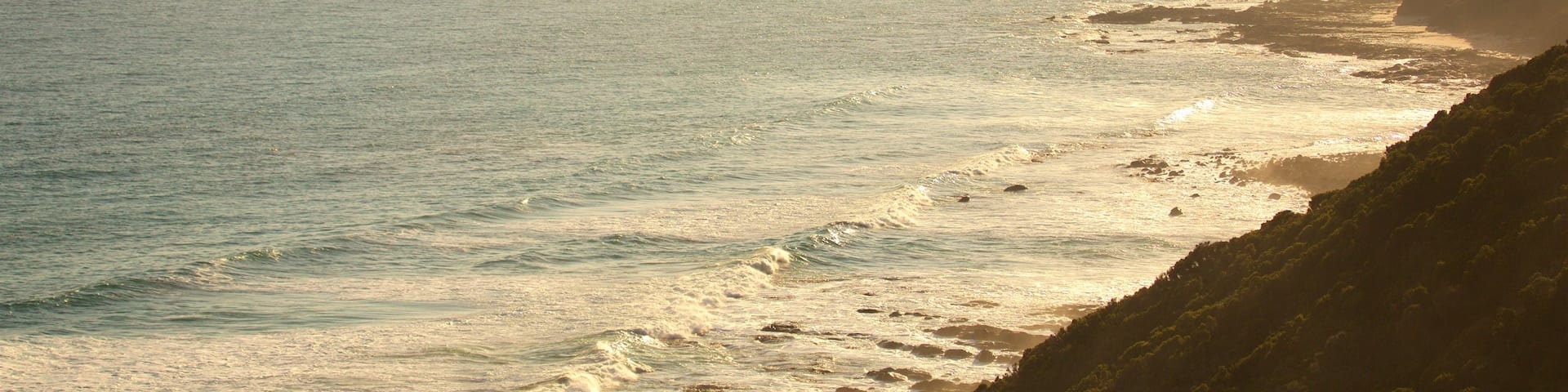 Great Ocean Road which includes general coastal views, mountains and a sunset