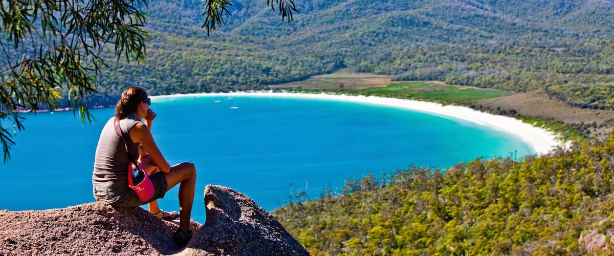 Freycinet featuring mountains and general coastal views as well as an individual femail