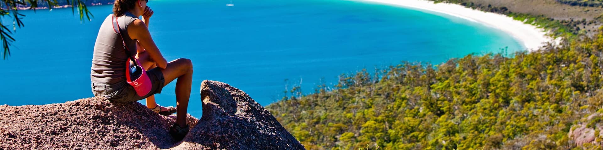 Freycinet featuring mountains and general coastal views as well as an individual femail
