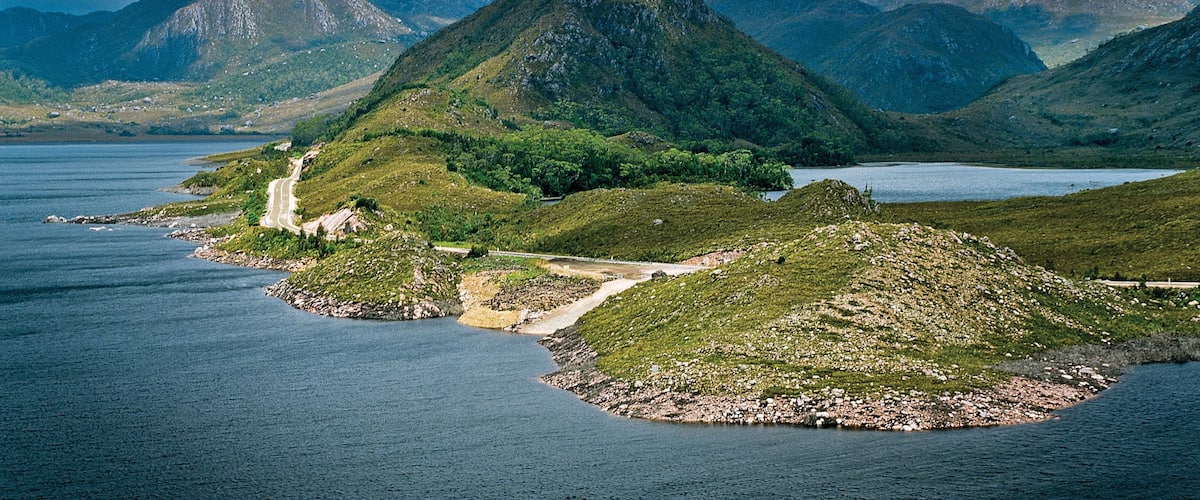 Zeehan which includes a lake or waterhole and mountains