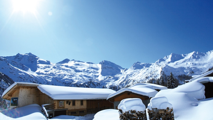 Hintertux which includes snow, mountains and a house