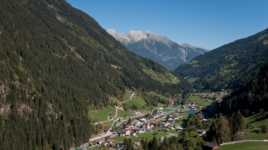 See which includes mountains and a small town or village