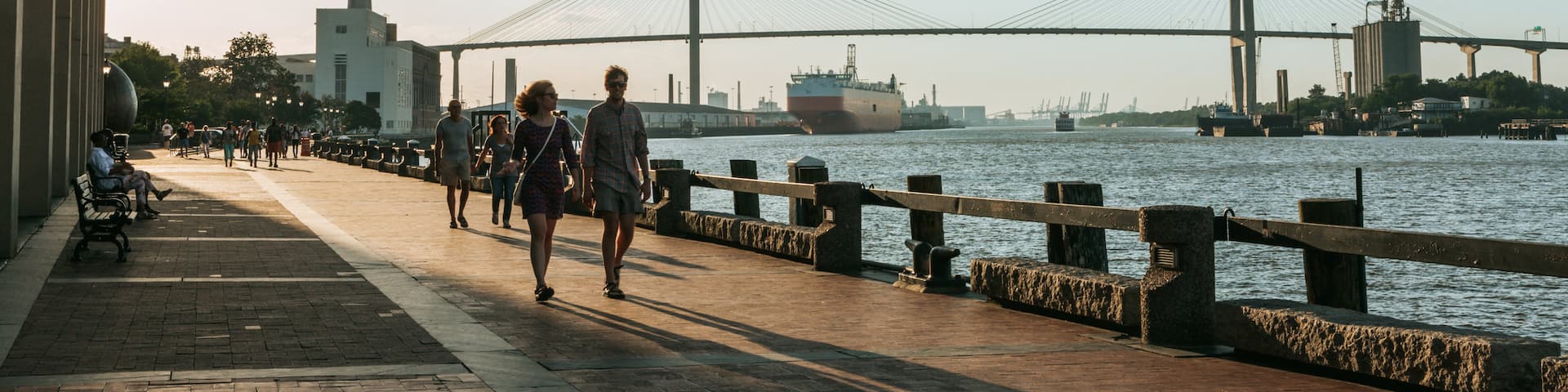 River Street showing a bridge and a river or creek as well as a small group of people