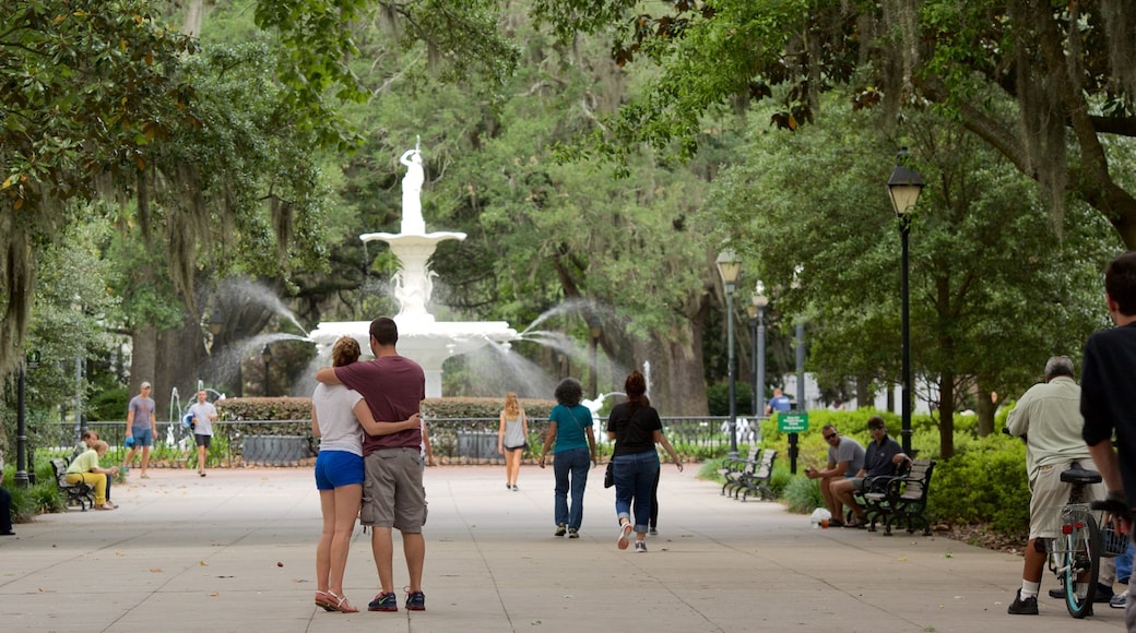 Forsyth Park featuring a park and a fountain as well as a small group of people