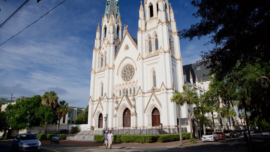 The Cathedral Basilica of St. John the Baptist in Savannah, Georgia, showcasing its striking twin spires and Gothic Revival architecture against a clear blue sky