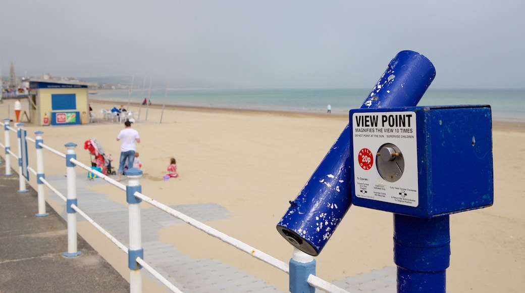 Weymouth Beach showing a sandy beach and views as well as a family