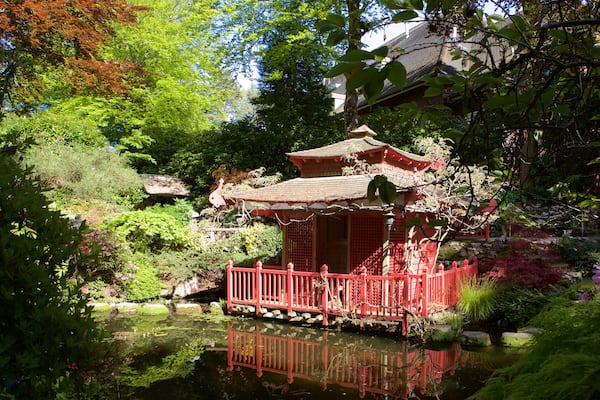 Compton Acres featuring a pond and heritage architecture
