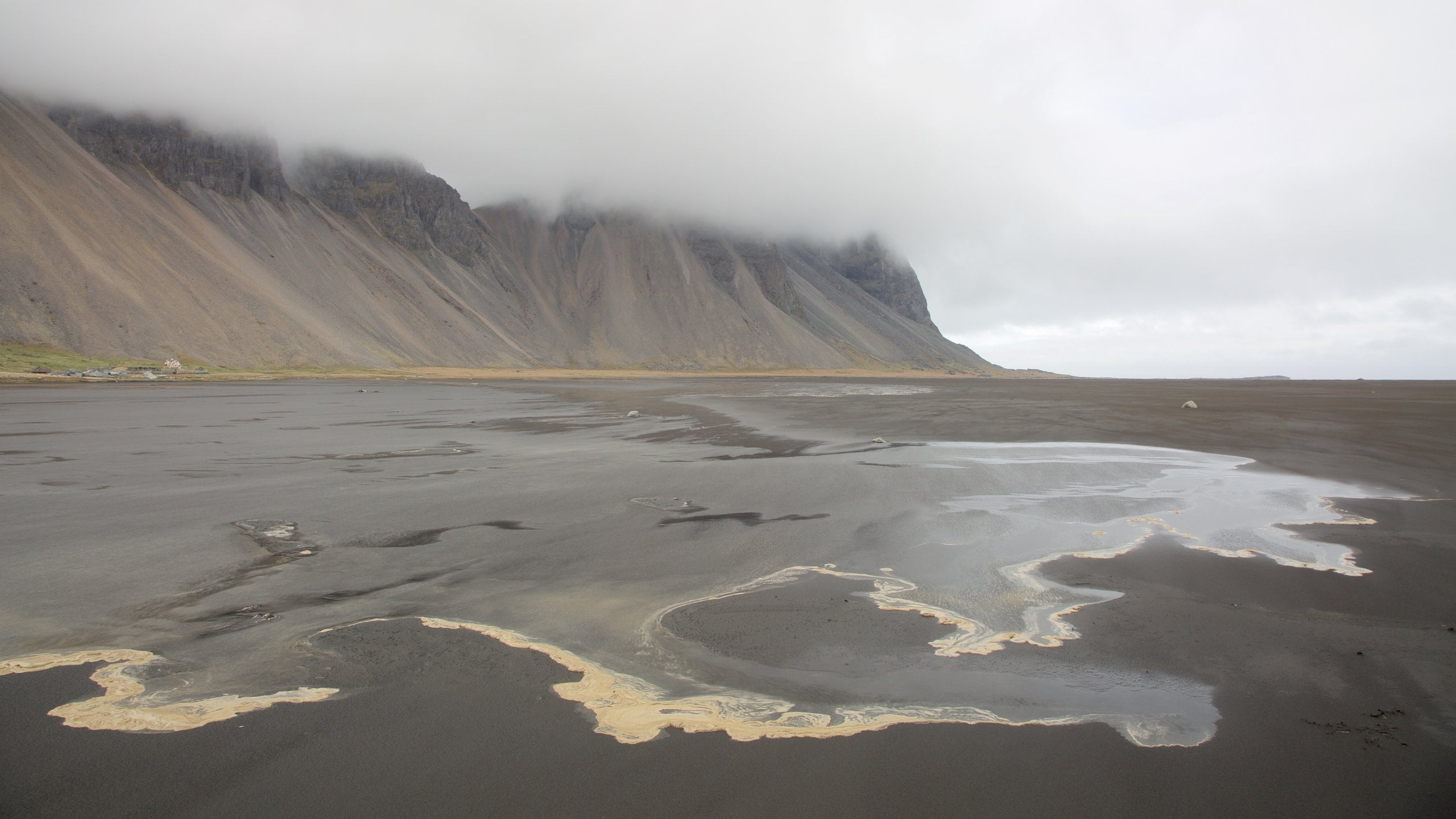 Hofn which includes mountains, general coastal views and mist or fog