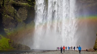 Skogar which includes a waterfall as well as a large group of people