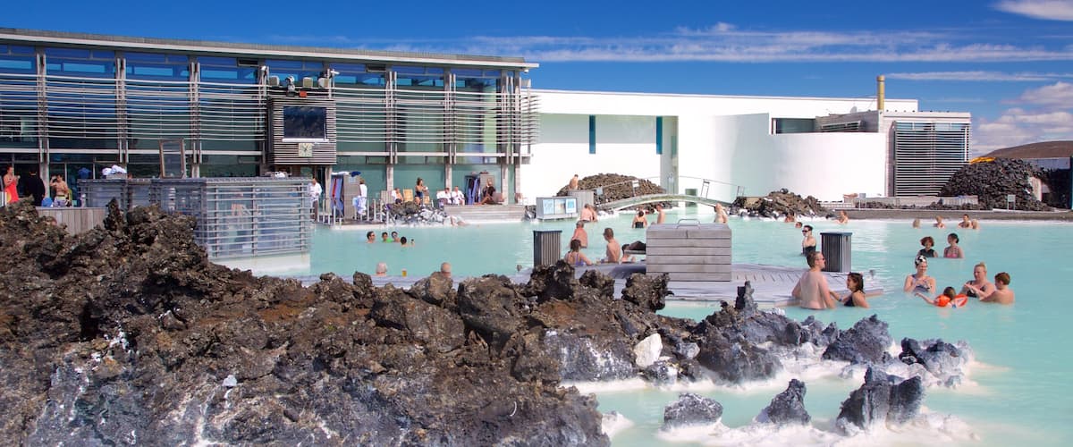 Blue Lagoon showing a luxury hotel or resort and a hot spring as well as a large group of people