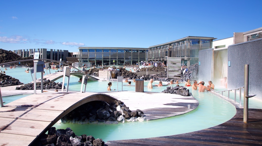 Blue Lagoon showing a luxury hotel or resort and a hot spring as well as a large group of people