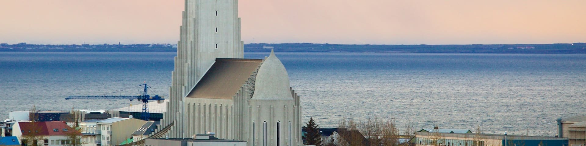 Hallgrimskirkja which includes a sunset, general coastal views and a church or cathedral