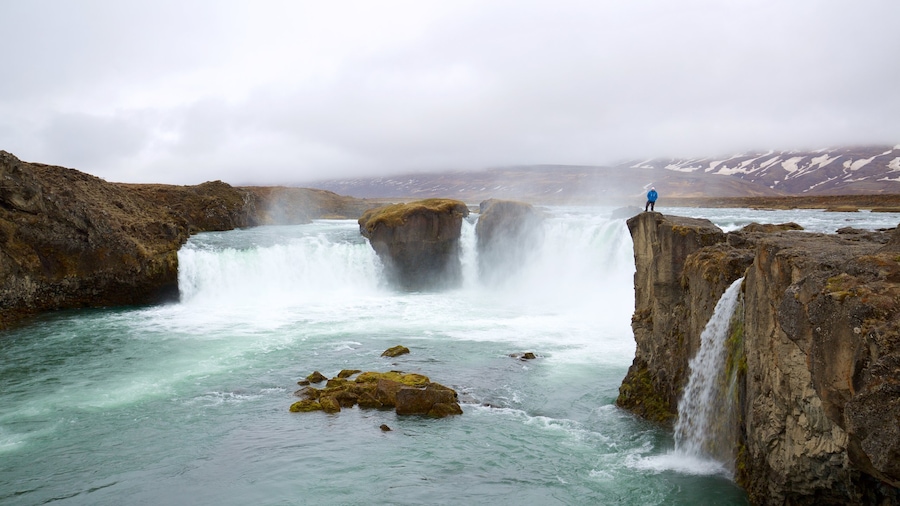 Godafoss which includes a waterfall and mist or fog