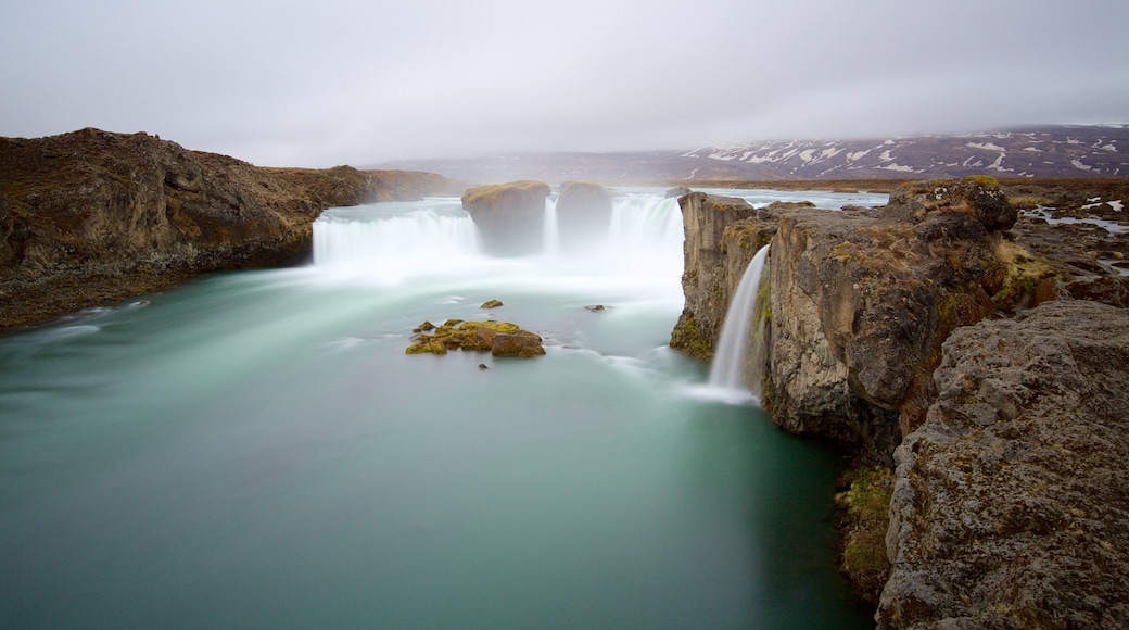 Godafoss which includes mist or fog, a cascade and a river or creek