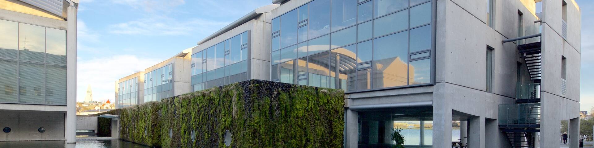Reykjavik City Hall which includes a pond and modern architecture