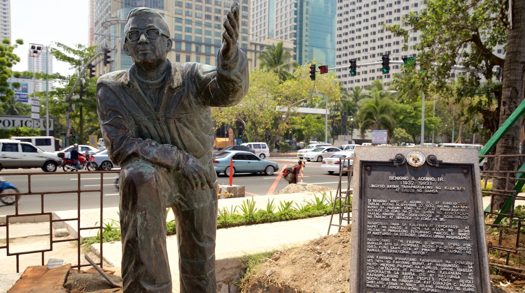 Manila Bay showing signage and a statue or sculpture