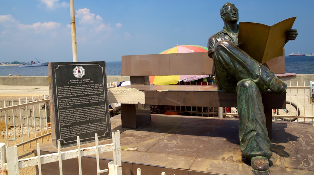 Manila Bay showing signage and a statue or sculpture