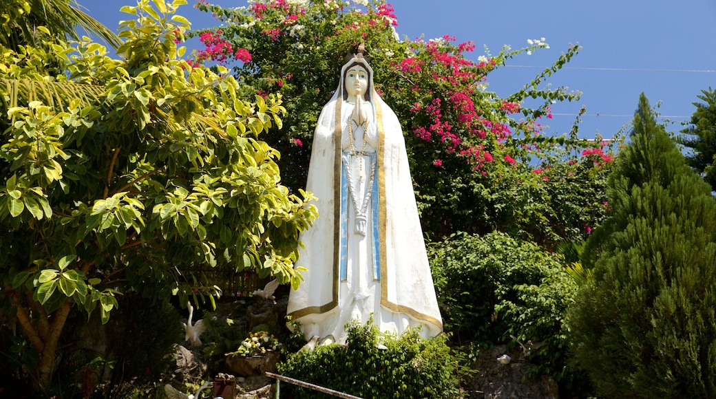 Simala Shrine featuring a statue or sculpture and a garden