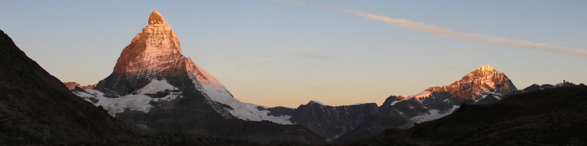 Matterhorn som omfatter bjerge, en solnedgang og sne