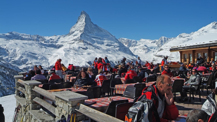 Sunnegga Ski Resort showing snow and mountains as well as a large group of people