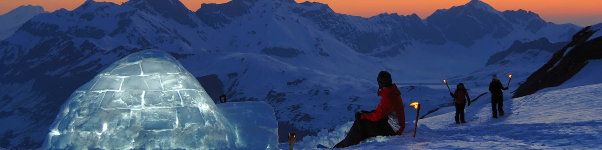 Engelberg-Titlis Ski Resort which includes a sunset and snow as well as a small group of people