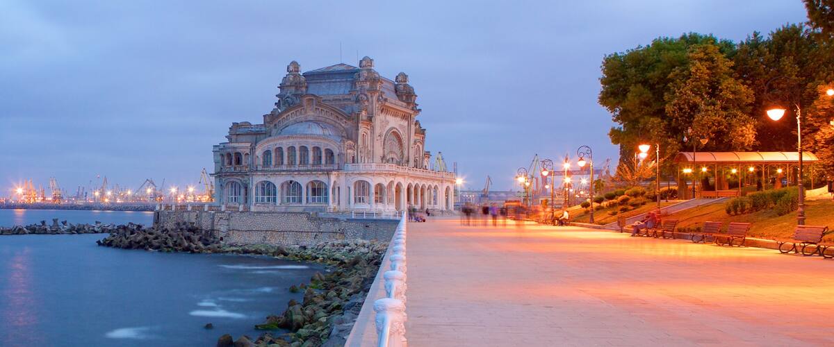 Constanta Casino showing rocky coastline and a sunset