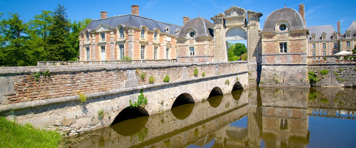 Chateau de la Ferte-St-Aubin mostrando un río o arroyo, un puente y una pequeña ciudad o pueblo
