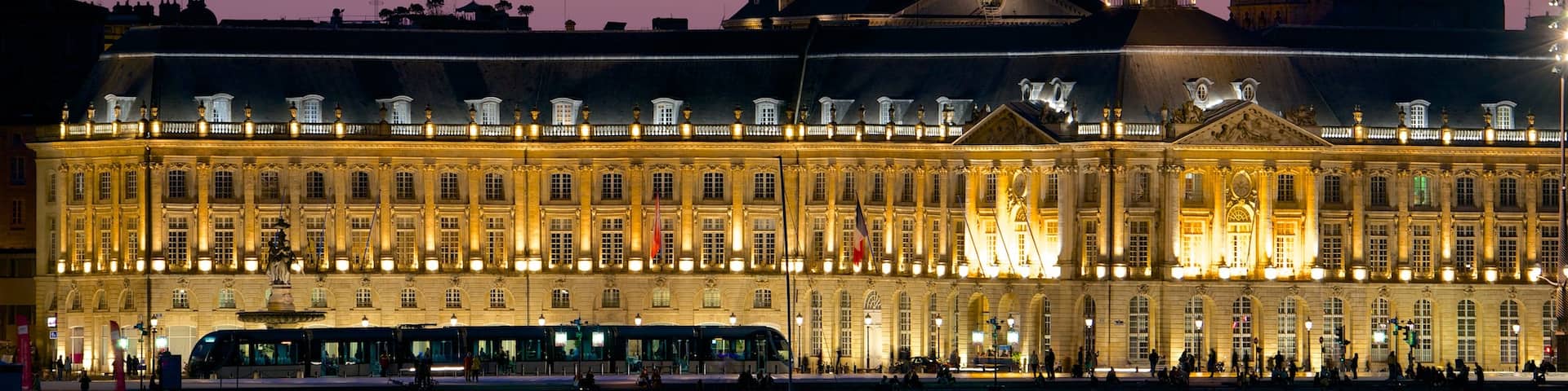 Place de la Bourse showing heritage architecture, night scenes and an administrative buidling