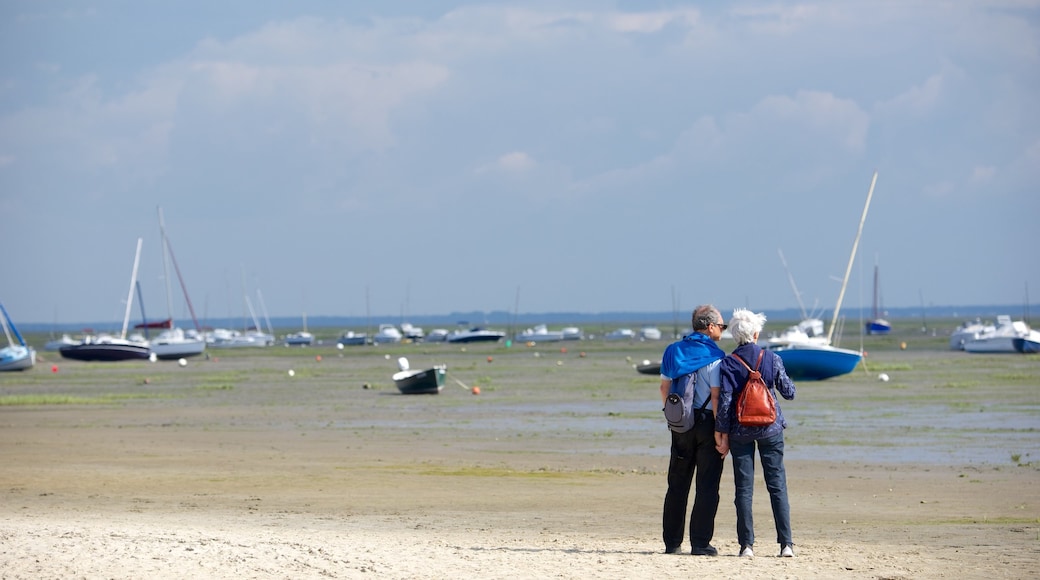 Bordeaux showing a sandy beach as well as a couple