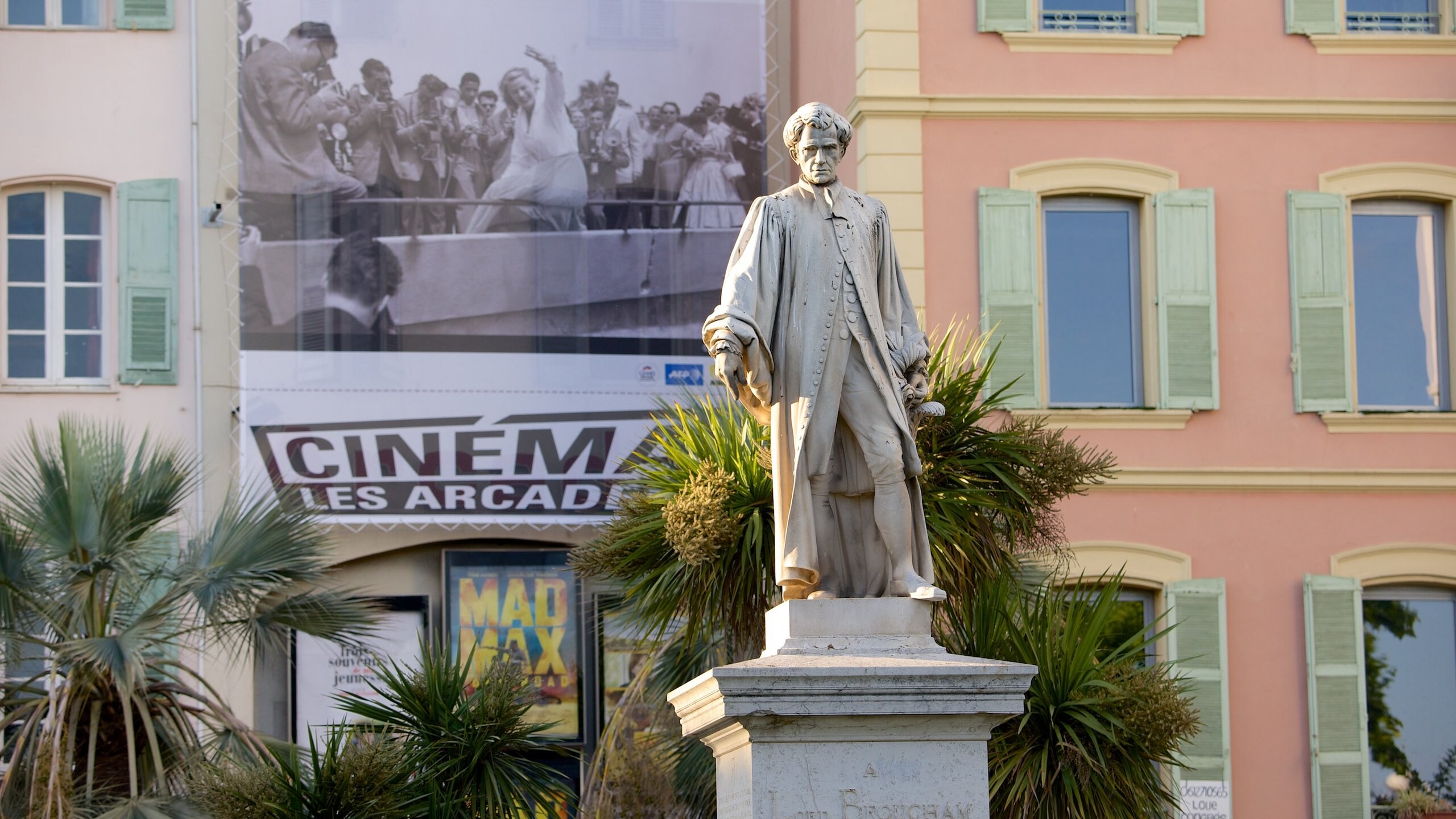 Cannes which includes signage and a statue or sculpture