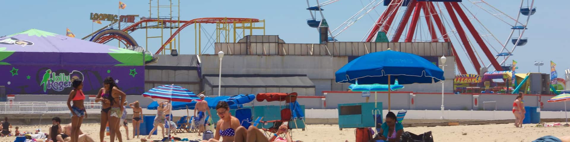 Ocean City Beach showing a beach and rides as well as a small group of people