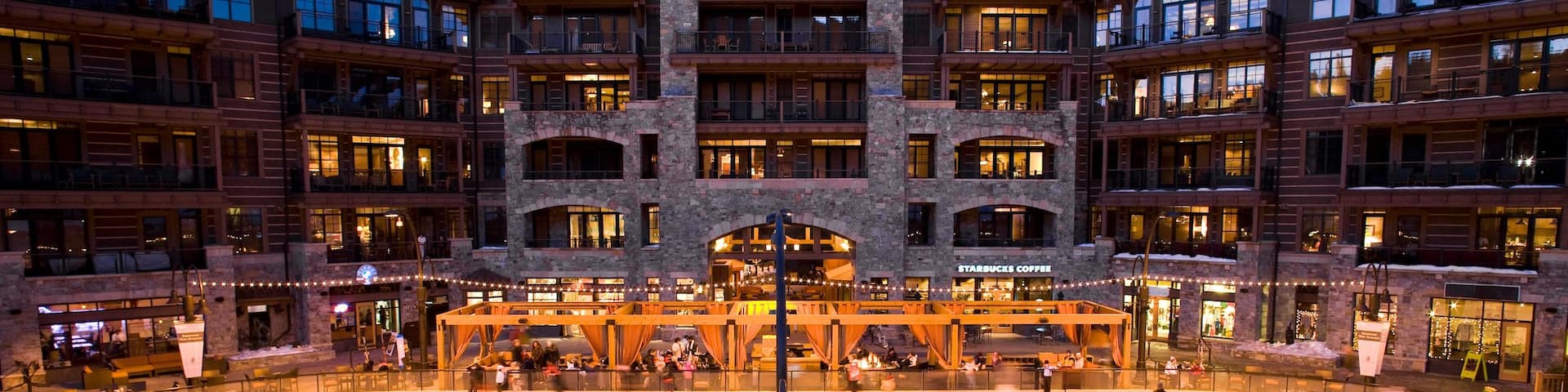 Northstar California Resort featuring a hotel and ice skating as well as a small group of people