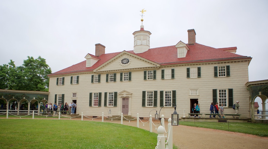  The image shows the front of a large white house with a red roof, which was the home of George Washington, the first president of the United States, and where a sealed cherry jar is displayed.