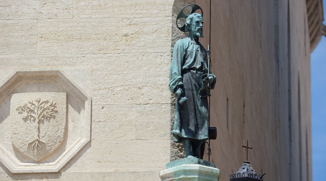 Liberty Square featuring a church or cathedral, a statue or sculpture and religious elements