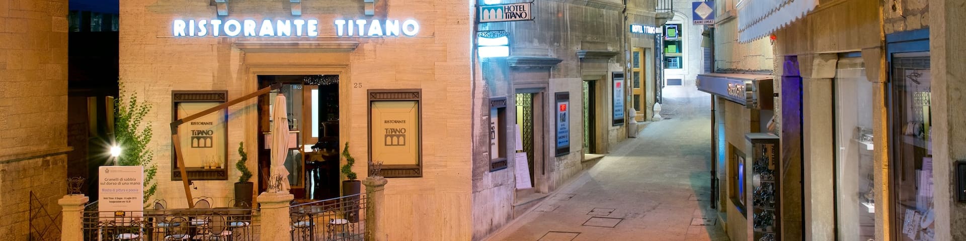 Piazza del Titano showing a city, night scenes and signage