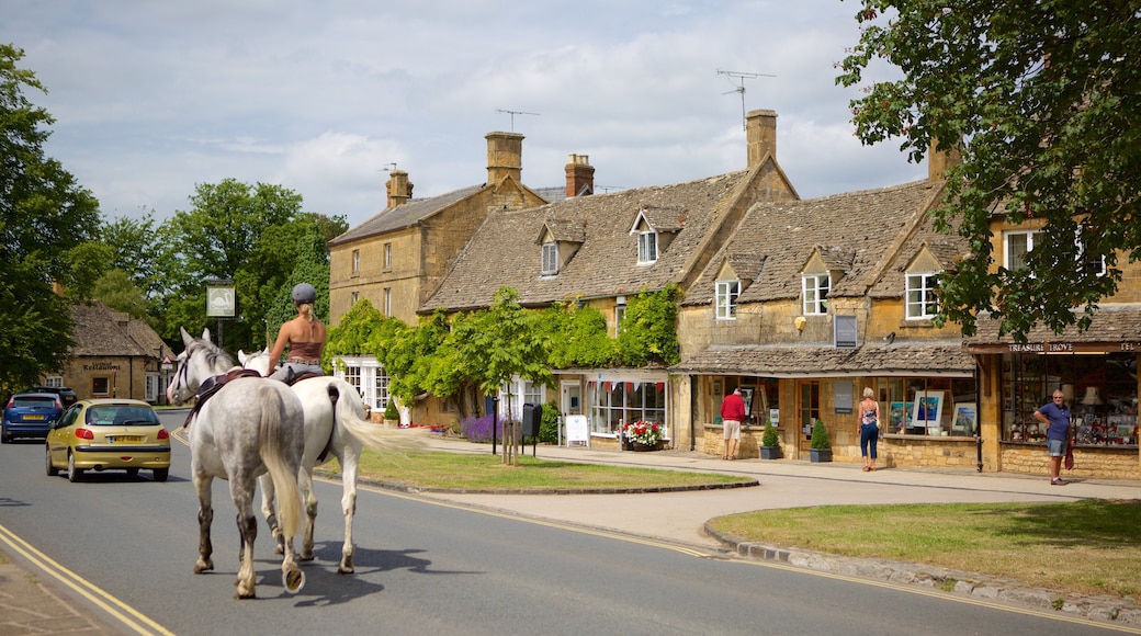 Broadway which includes a small town or village, street scenes and horse riding