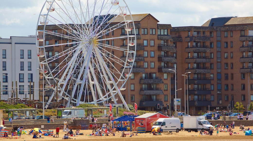 Weston-super-Mare featuring a sandy beach, a coastal town and rides