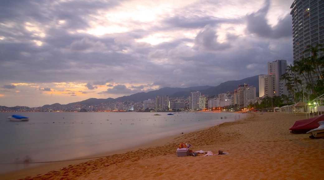 Icacos Beach featuring a sandy beach, a sunset and a coastal town