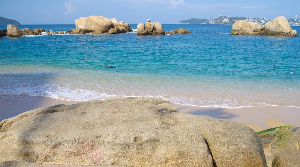 Condesa Beach showing a beach and rocky coastline