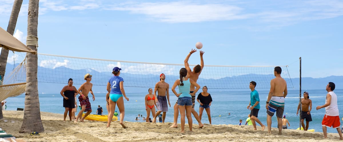 Nuevo Vallarta Beach which includes a beach and a playground as well as a large group of people