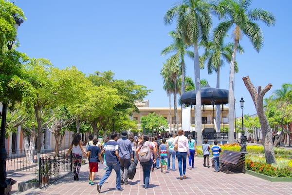 Plaza Machado which includes a square or plaza and a park as well as a large group of people
