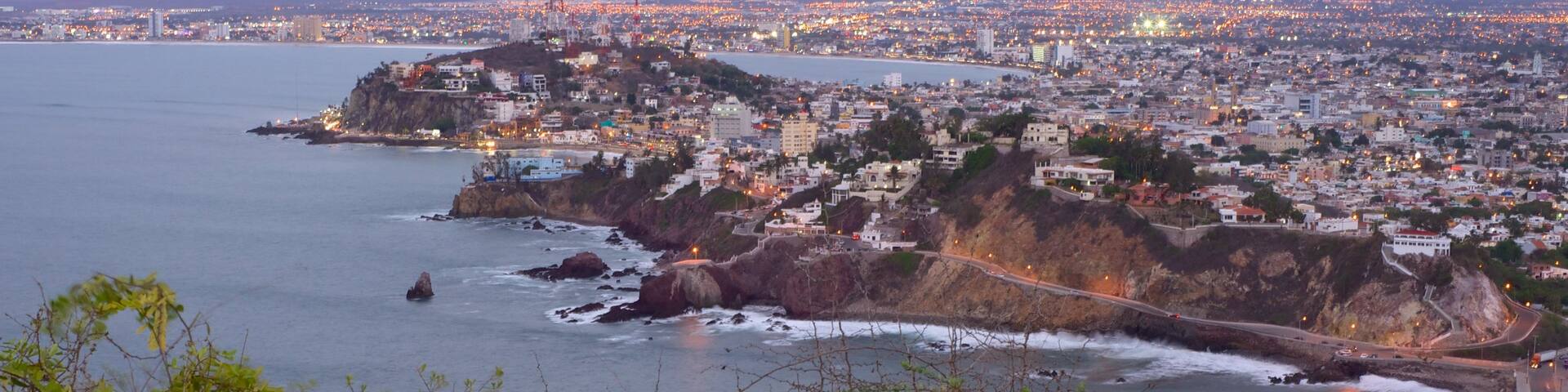 El Faro Lighthouse which includes a coastal town, rocky coastline and general coastal views