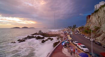 Olas Altas Beach featuring a sunset, street scenes and a gorge or canyon