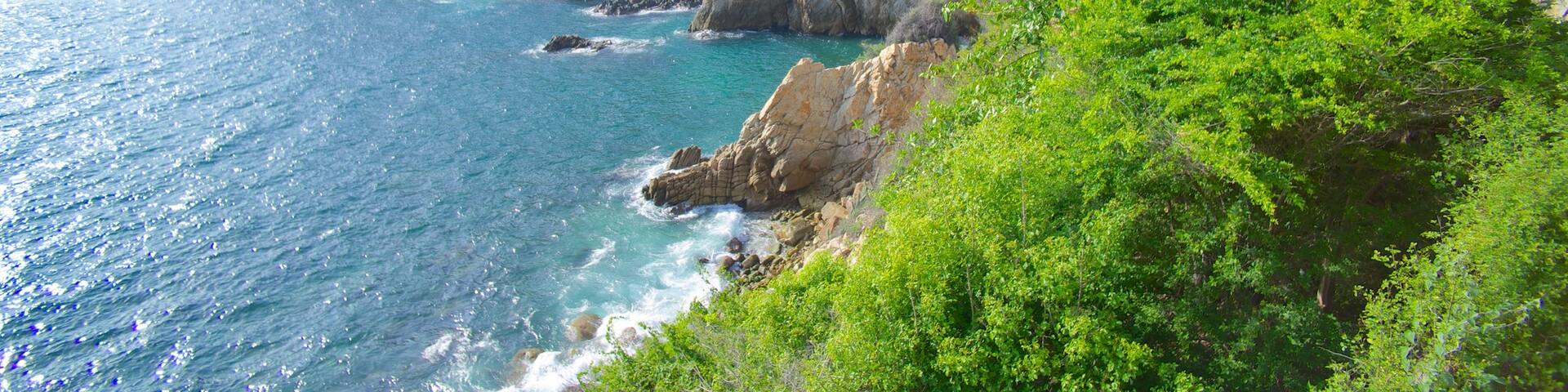 La Quebrada Cliffs featuring rocky coastline, a gorge or canyon and a coastal town
