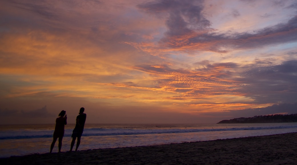 Zicatela Beach mostrando una playa y una puesta de sol y también una pareja