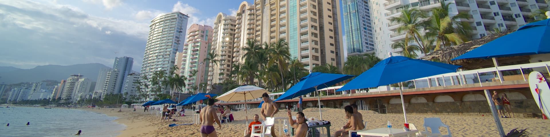 Playa Icacos ofreciendo una playa de arena, una ciudad costera y una ciudad